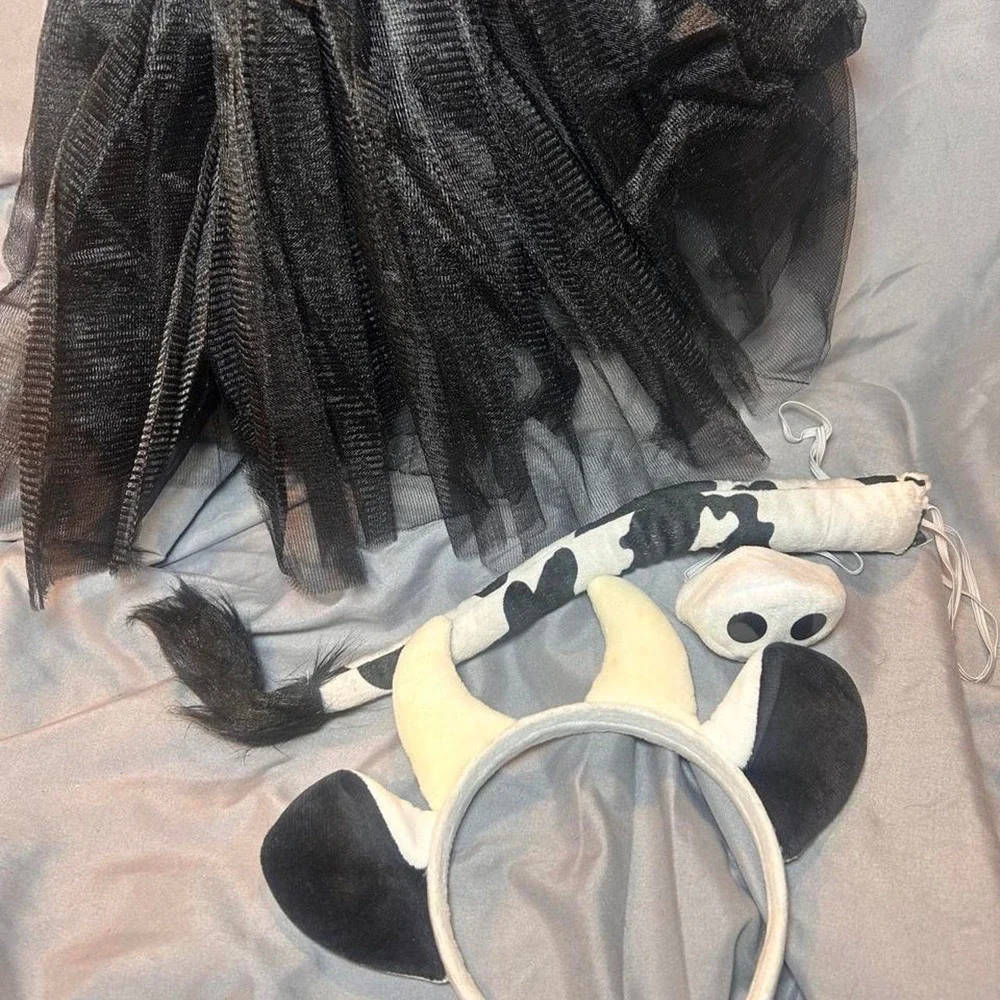 Cow costume with black and white cow print headband and tail